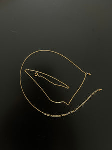 Gold body chain with tiger eye gemstone pendant.